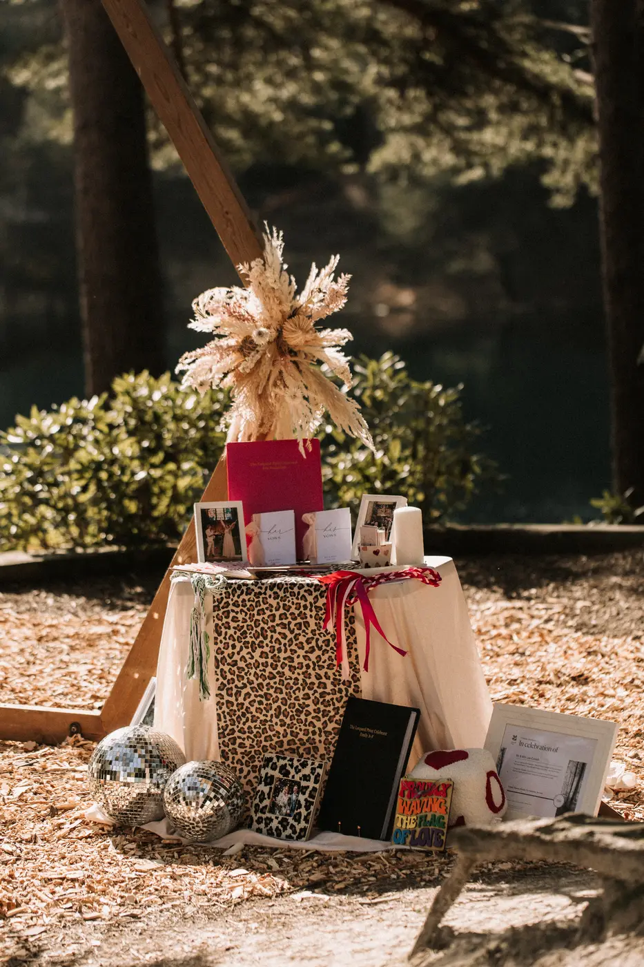 A stationery display on a leopard-print cloth with disco balls and dried flowers.